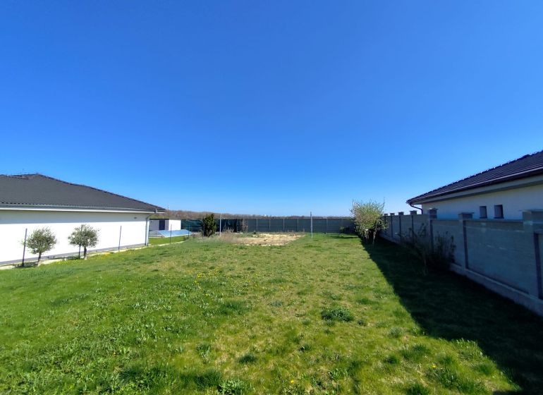 Land on Rekreačná Street in Biely Kostol with a landscaped green grassy area for living.