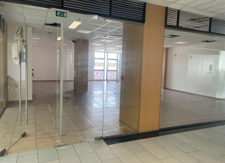 Glass door-inspired commercial spaces with light ceramic tiles.