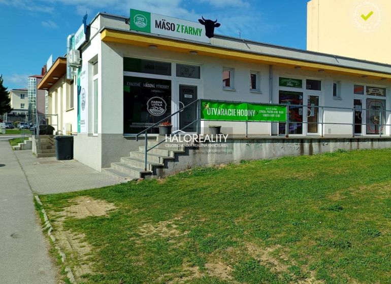 Commercial premises in Žiar nad Hronom with meat advertisement on a white exterior.