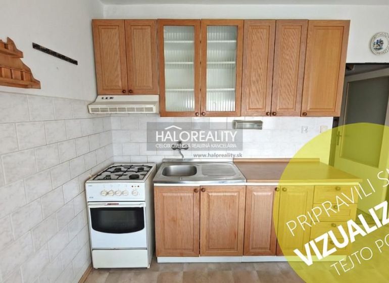 A kitchen in a 4-room apartment with wooden cabinets and a gas stove.