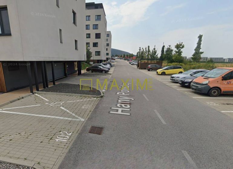 Garages on Hany Ponická Street in Bratislava - Lamač with parking spaces and cars.