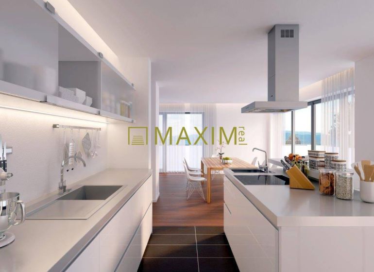 A kitchen in a 2-room apartment with a wooden decor floor and a dining table.
