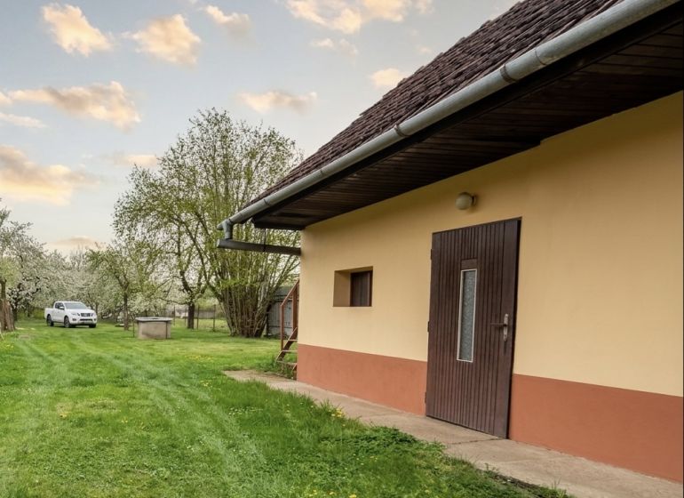 Exterior of a house with a lawn on Biskupická Street in Trenčín, Land - housing.