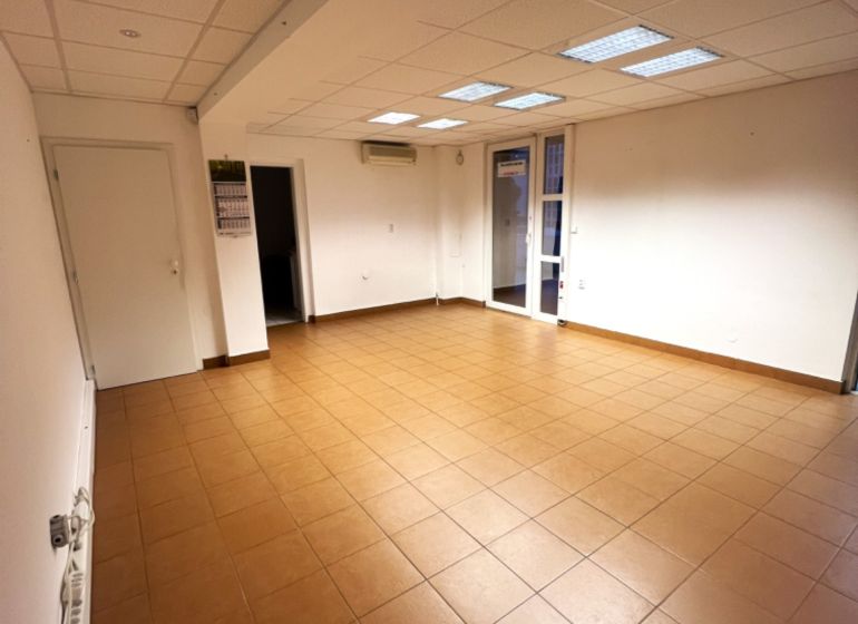Offices with tiled floors, white walls, and a coffered ceiling.