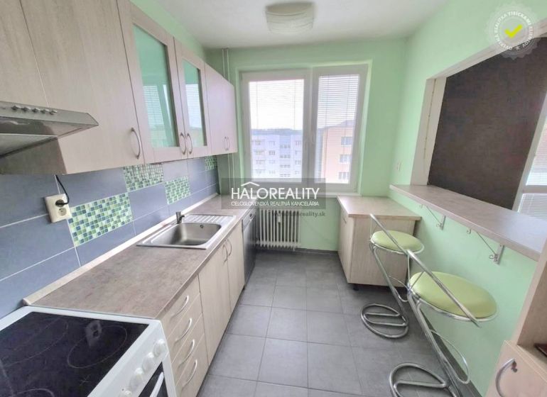 A kitchen with tiles and bar stools in a 3-room apartment.