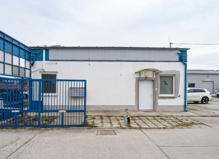 The blue gate leads to the industrial area on Bulharská Street in Trnava.