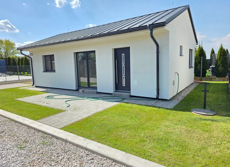 A family house in Kajal, with a lawn and terrace, ideal for living.