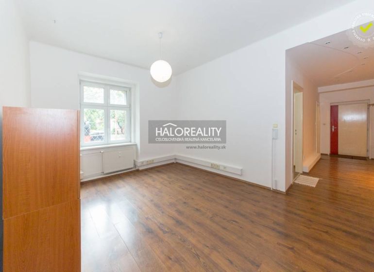 Living room in a five or more room apartment with wooden flooring and a large window.