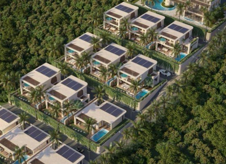 Construction of houses in Nungwi with swimming pools and solar panels, surrounded by greenery.