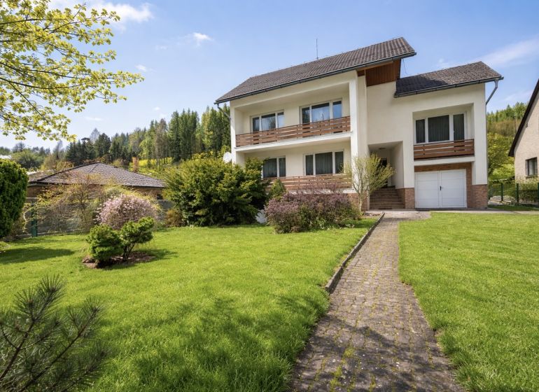 A family house on Čadečka Street in Čadca, surrounded by a beautiful garden and an access walkway.