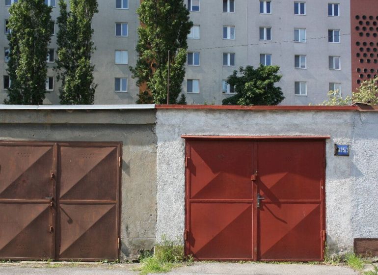 Garages on Varšavská Street in Bratislava - Nové Mesto, residential building in the background.