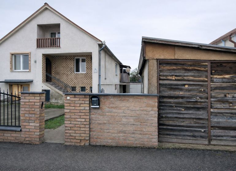 A family house on Antona Bernoláka Street in Kolárovo, with a separate wooden garage next to it.