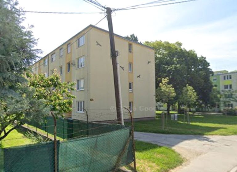 An apartment building on Lipová Street in Piešťany surrounded by greenery and trees.