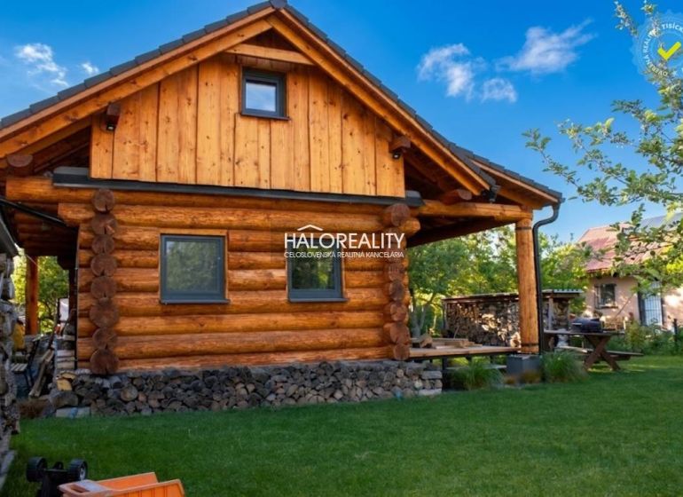A wooden cottage in Piešťany surrounded by greenery with wood in stock.