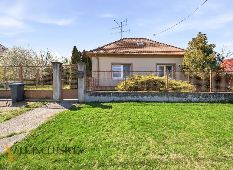 A family house in Vydrany near Dunajská Streda with a front garden and a metal fence.
