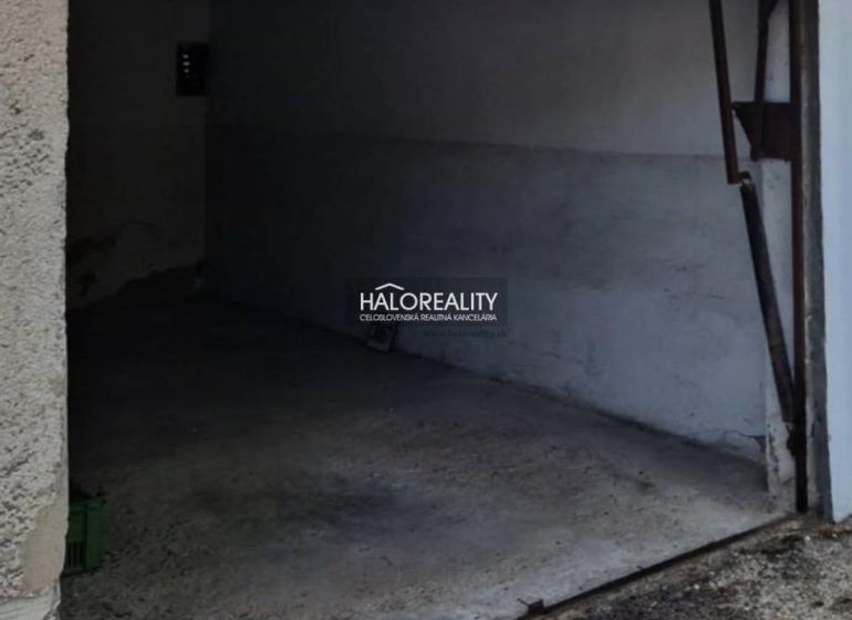 A garage in Dunajská Streda with a concrete floor and open doors.