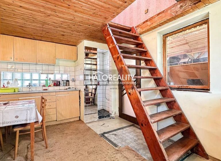 Rustic kitchen with stairs and wooden ceiling in Záhrady near Nové Zámky.