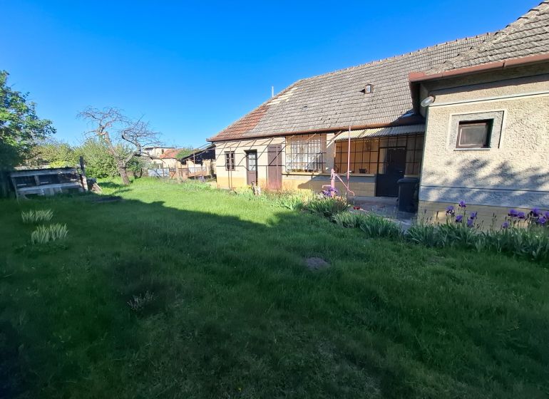 A family house in Tvrdošovce with a large garden and flower beds.