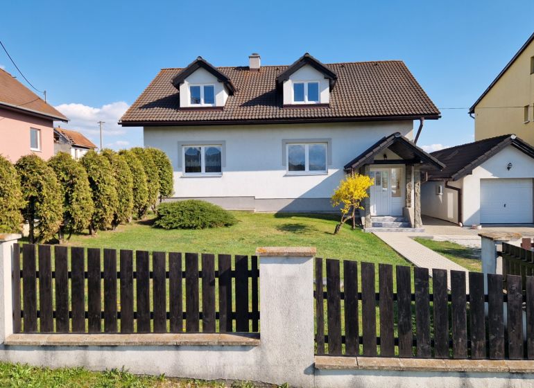 A family house in Spišský Štvrtok with a garage, garden, and landscaped exterior.