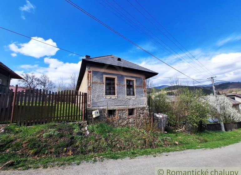 An old house with a decorated facade in the village of Heľpa, Unique properties on the hill.