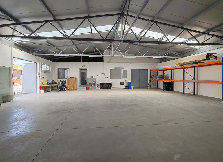 Interior with storage shelves, a motorcycle, and a workbench, Warehouses and halls.