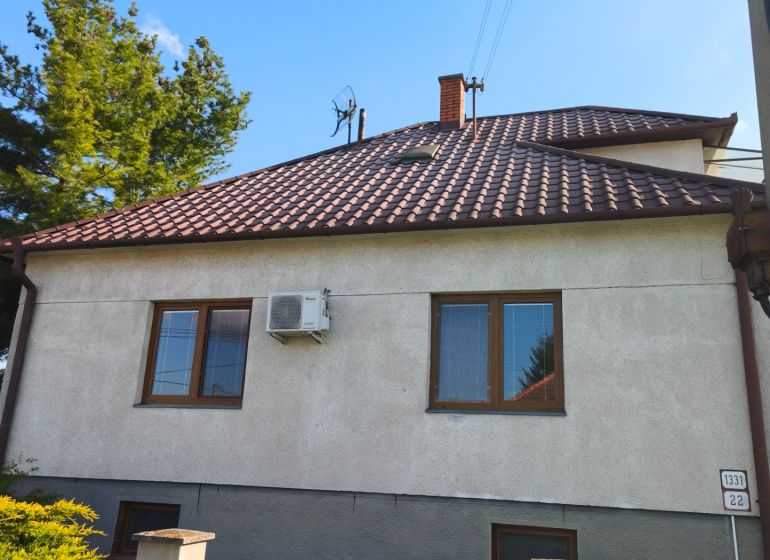 A family house in Zlaté Moravce with a sloped roof and a well-maintained garden.