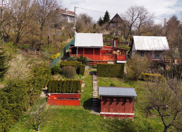 A cottage on Kavečianska Road in Košice, Sever district, surrounded by a garden and trees.