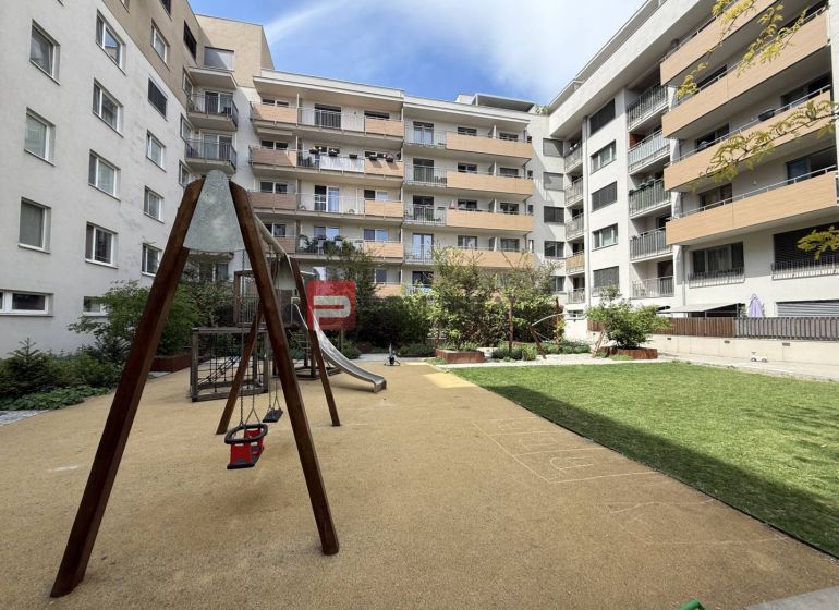 Courtyard with a children's playground surrounded by apartment buildings on Galvaniho in Bratislava II.