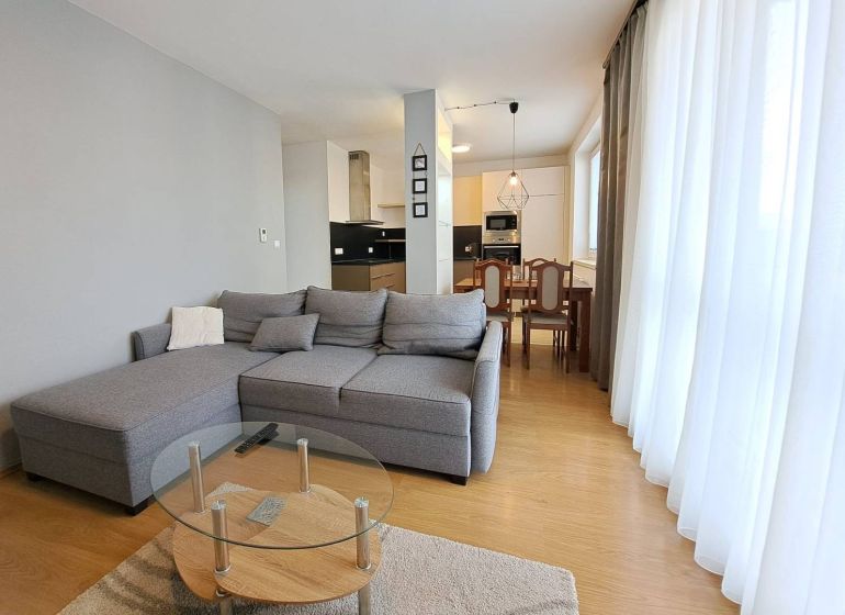 Living room in a 3-room apartment with a corner sofa and a kitchenette.