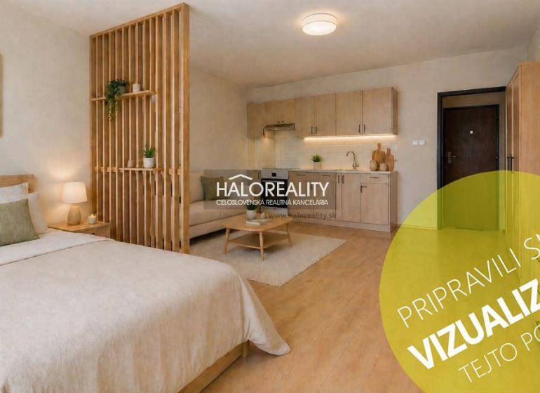 Studio apartment with a bed, kitchenette, and wood-patterned flooring.