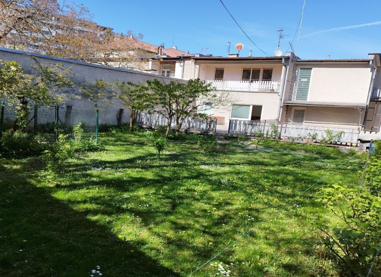 A family house in the center of Banská Bystrica on Komenského Street with a grassy yard.
