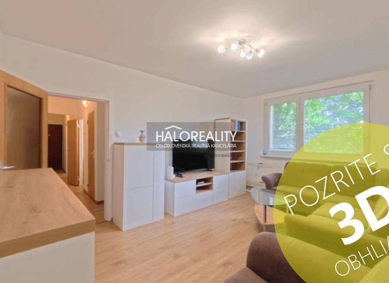 Living room in a two-room apartment with a wooden decor floor and a comfortable sofa.