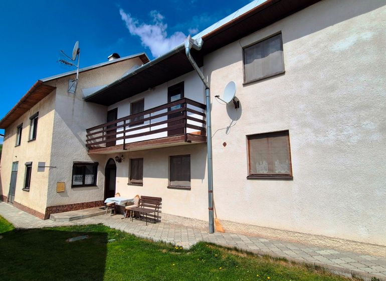 A family house in Jarabina on Jarabina Street with a balcony and a landscaped garden.