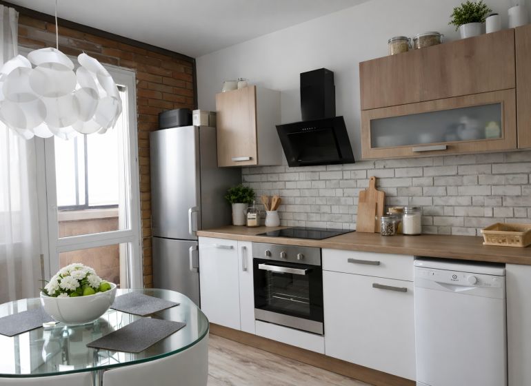 A bright kitchen with appliances, a dining table, and a wooden decor floor in a 4-room apartment.