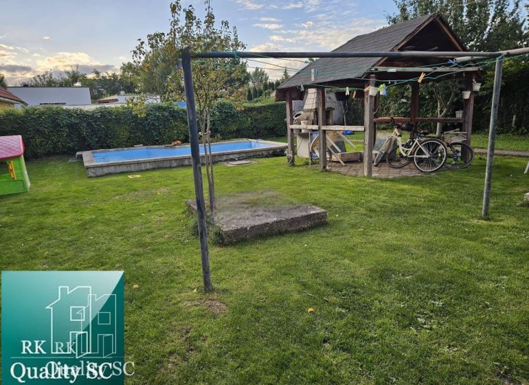 The garden of a family house in Tureň, Tureň with a gazebo, swimming pool, and lawn.