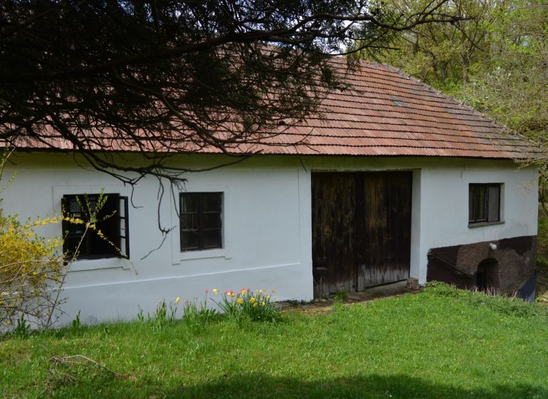 A family house in Bukovec with a sloped roof and wooden gates.
