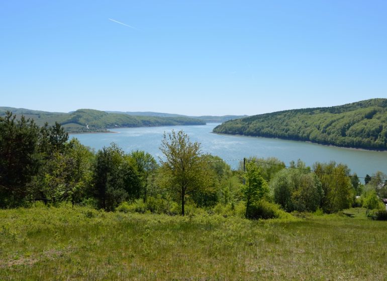 View from the recreational lands in Nová Kelča to the lake surrounded by forests.