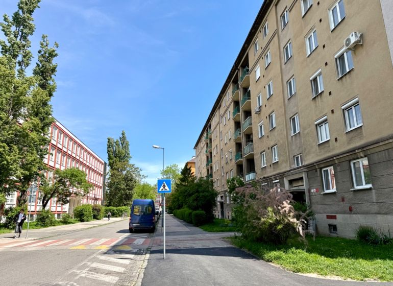 Jelačičova Street in Bratislava - Ružinov with apartment buildings and greenery.