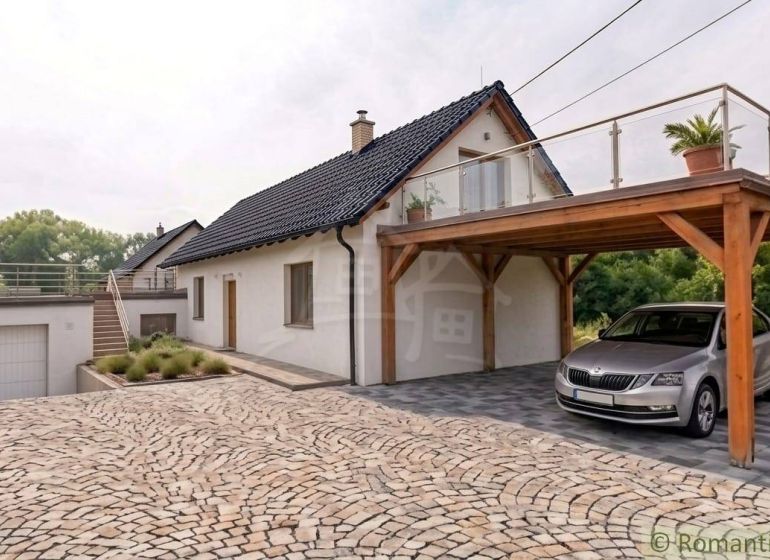 A family house in Sobotište with a sloped roof, terrace, and wooden carport.