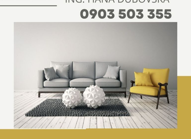 Living room with a sofa and an armchair, decorative elements on wooden floor decor.