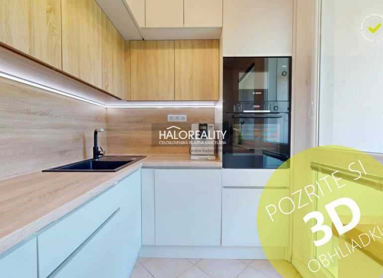 A kitchen in a 3-room apartment with light cabinets and a wood-patterned floor.