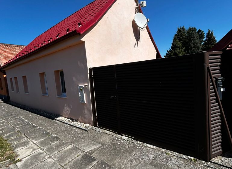 A family house on Mikulášov in Lakšárska Nová Ves with a red roof and a satellite.