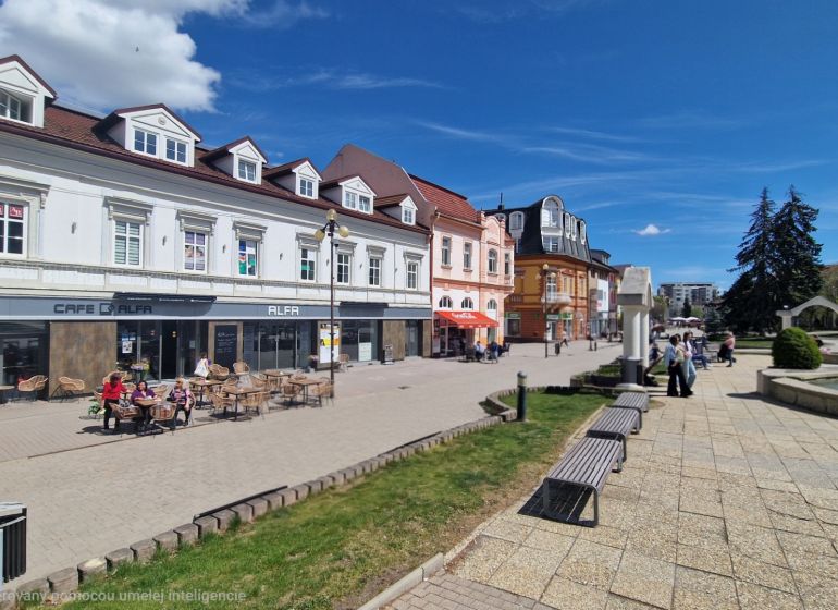 Offices on Sv. Egídia Square in Poprad with a café and benches next to the fountain.