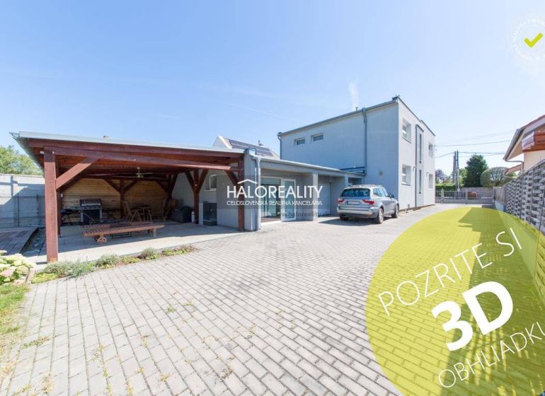 A family house in Vrakuňa with a carport and a landscaped garden.