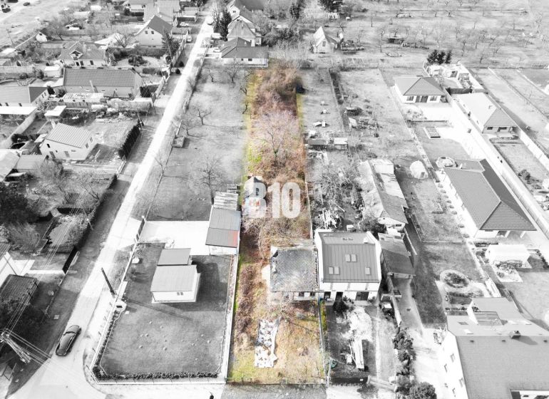 Aerial view of a plot with a house, suitable for living in a suburban area.