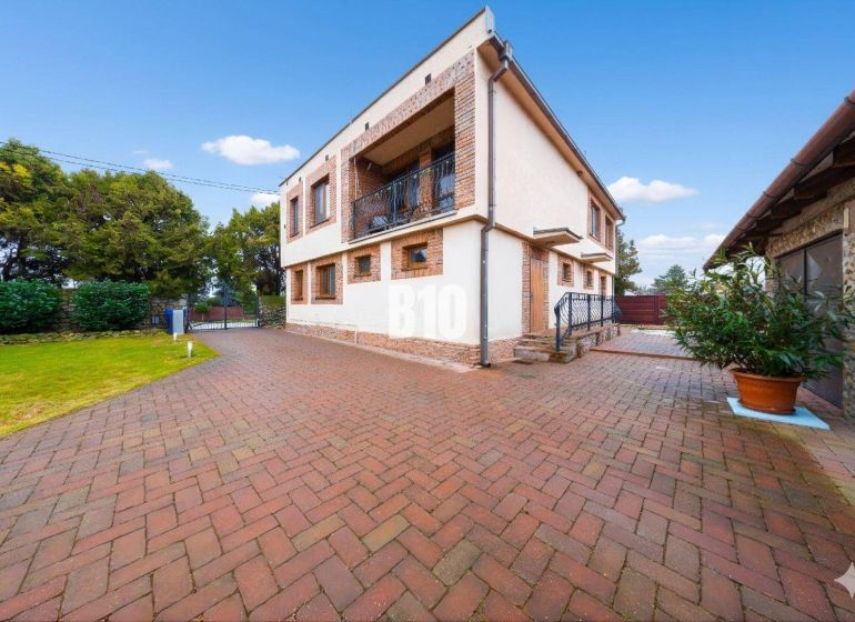 A family house in Štvrtok na Ostrove with a spacious yard and garden, brick design.