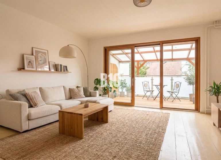 A living room in a family house with a light sofa, a wooden table, and a spacious terrace.