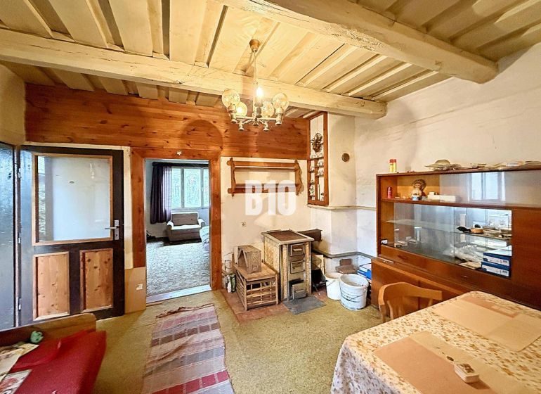 Interior of a family house with traditional furnishings, tiles, carpets, and wooden decor.