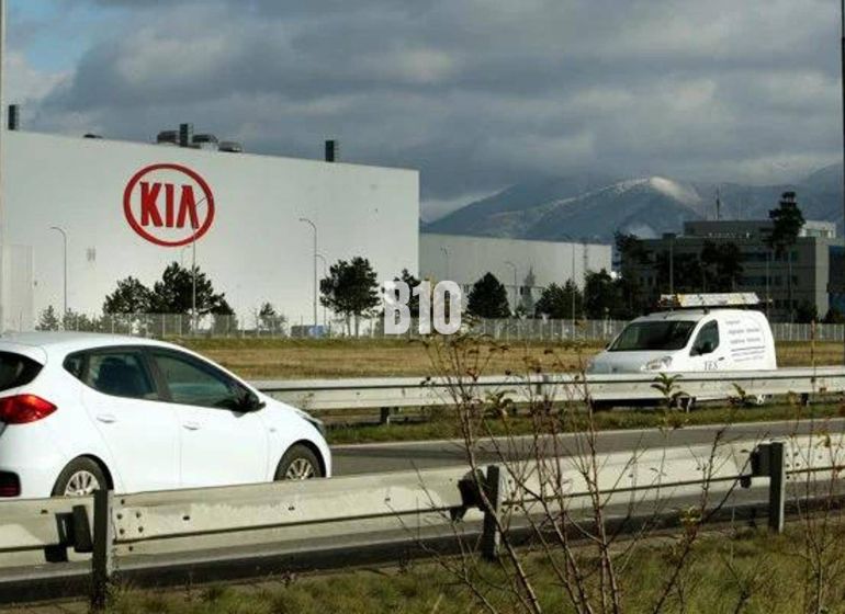 KIA Motors plant in Slovakia, cars on the highway, commercial land in the background.