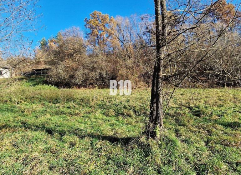 Extensive residential plots in Bytča, surrounded by trees with a property in the background.